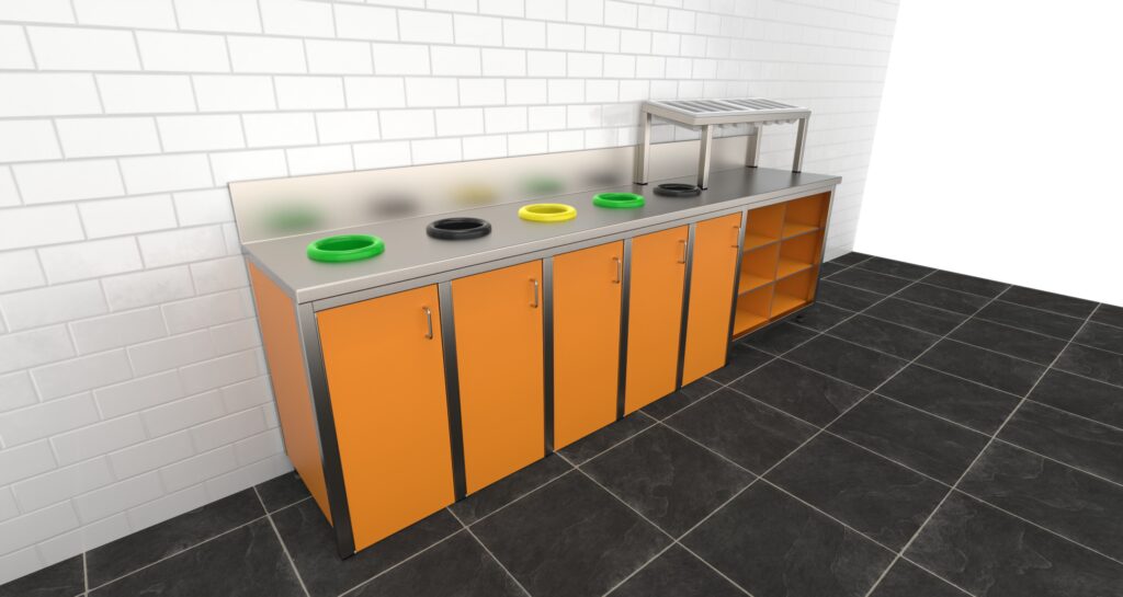 Debrasseermeubel met oranje fronten en rvs blad, voorzien van meerdere afvalopeningen, geplaatst tegen een witte tegelwand.